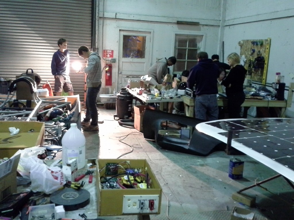 The team working on all three of mechanical components, electrical boards and connectors, and controller board code! The bottom shell and chassis is on the left, and the top shell and solar array is on the right.